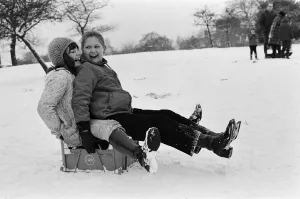 Children sledging on a milk crate in Greenwich Park, London, 27th December 1970 Children sledging on a milk crate in Greenwich Park, London, 27th December 1970