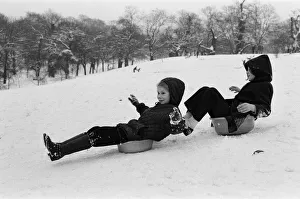 Children sledging on washing up bowls in Greenwich Park, London, 27th December 1970 Children sledging on washing up bowls in Greenwich Park, London, 27th December 1970