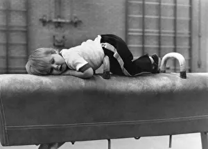Children: Sports: Taking a break: After a work-out, Sean lies down on a vaulting horse Children: Sports: Taking a break: After a work-out, Sean lies down on a vaulting horse