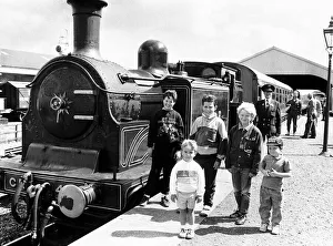 Children stand next to the Caledonian loco No 419 Steam Train owned by the Scottish Children stand next to the Caledonian loco No 419 Steam Train owned by the Scottish