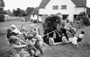 Children from the village of Longarish pull along a giant teddy bear on a trolley through Children from the village of Longarish pull along a giant teddy bear on a trolley through
