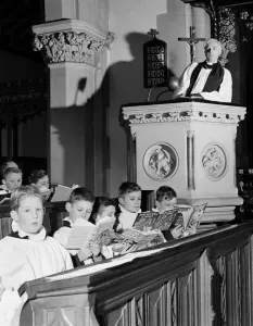 Choirboys reading their books in church during a priests sermon Circa 1954 Choirboys reading their books in church during a priests sermon Circa 1954