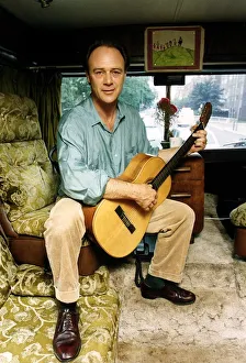 Christopher Cazenove actor sitting in his motor home playing guitar Christopher Cazenove actor sitting in his motor home playing guitar