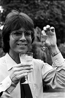 Cliff Richard with his OBE medal award drinkng wine 1980 Cliff Richard with his OBE medal award drinkng wine 1980