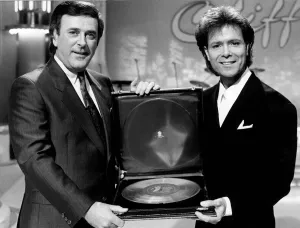 Cliff Richard Singer actor with Terry Wogan receiving award. November 1988 Cliff Richard Singer actor with Terry Wogan receiving award. November 1988