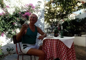 Clive Dunn actor sitting at table outside house drinking wine November 1989 Clive Dunn actor sitting at table outside house drinking wine November 1989