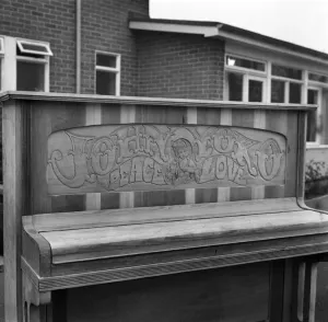 Close up of the carving on the John Lennon piano which says Joan and Yoko, Pease and Love Close up of the carving on the John Lennon piano which says Joan and Yoko, Pease and Love