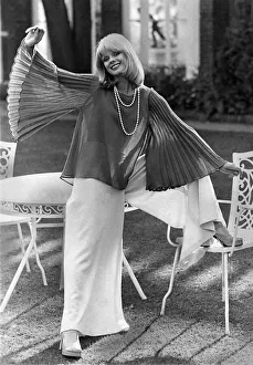 Clothing: Fine wool crepe blouse, flaring from rounded neckline, has wide pleated sleeve Clothing: Fine wool crepe blouse, flaring from rounded neckline, has wide pleated sleeve