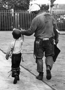 A coal miner walking his son, a junior miner. October 1978 P017740 A coal miner walking his son, a junior miner. October 1978 P017740