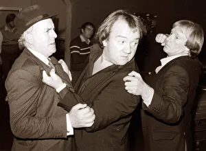 Comedian Mel Smith in a scuffle with stars of the television series Minder George Cole Comedian Mel Smith in a scuffle with stars of the television series Minder George Cole