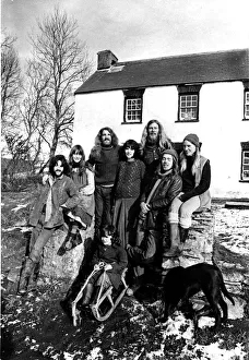 Communes - Eight members of the commune pose in the sunshine outside their farmhouse at Communes - Eight members of the commune pose in the sunshine outside their farmhouse at