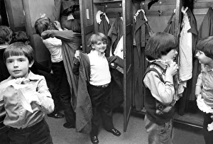 There is a controlled scramble as the boys get into their surplices There is a controlled scramble as the boys get into their surplices