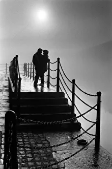 A couple enjoy the magic mood created by the fog at Liverpool's Albert Dock A couple enjoy the magic mood created by the fog at Liverpool's Albert Dock