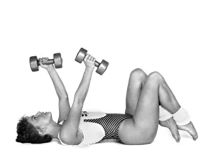 The Crunch. Lie on back, knees bent, feet flat. Hold weights with arms out The Crunch. Lie on back, knees bent, feet flat. Hold weights with arms out