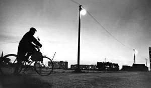 A cyclist taking a break as he rides through wasteland in Everton A cyclist taking a break as he rides through wasteland in Everton