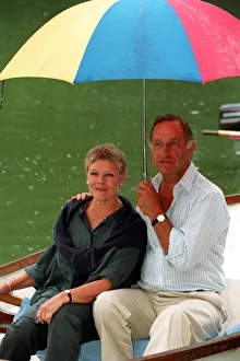 DAME JUDi DENCH & GEOFFREY PALMER (HOLDING UMBRELLA) SEATED IN ROWING BOAT DURING FILMING DAME JUDi DENCH & GEOFFREY PALMER (HOLDING UMBRELLA) SEATED IN ROWING BOAT DURING FILMING