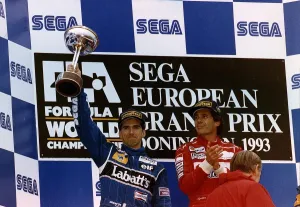 Damon Hill Formula 1 Motor Racing Driver Shows His Trophy After Coming Second In The Damon Hill Formula 1 Motor Racing Driver Shows His Trophy After Coming Second In The