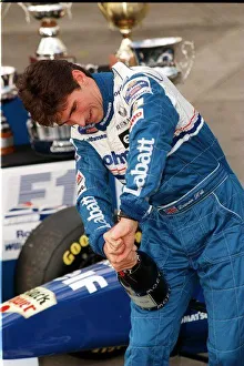 Damon Hill Formula One Drivers Champion having trouble opening a bottle of champagne at Damon Hill Formula One Drivers Champion having trouble opening a bottle of champagne at