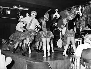 Dancing girls in mini-kilts and sporrans performing at the Caledonian Suite night club Dancing girls in mini-kilts and sporrans performing at the Caledonian Suite night club