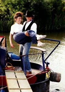 David Essex singer and actor on a barge boat carring a woman in a scene from his TV David Essex singer and actor on a barge boat carring a woman in a scene from his TV