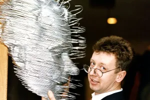 David Mack artist with his sculpture of human face made out of coat hangers David Mack artist with his sculpture of human face made out of coat hangers