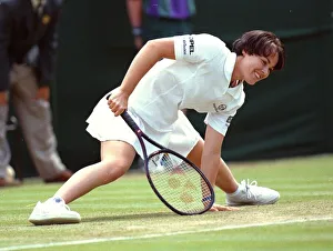 Defending champion Martina Hingis recovers from a slip Defending champion Martina Hingis recovers from a slip