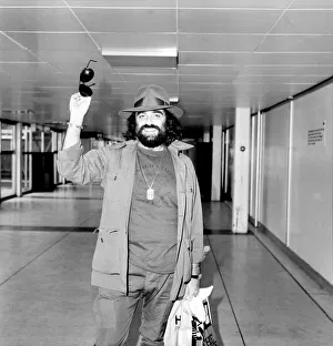 Demis Roussos leaving Heathrow Airport for Abu Dhabi. He is with a show Demis Roussos leaving Heathrow Airport for Abu Dhabi. He is with a show