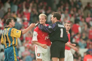Dennis Bergkamp is congratulated by Arsenal goalkeeper David Seaman as they celebrate Dennis Bergkamp is congratulated by Arsenal goalkeeper David Seaman as they celebrate
