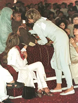 Diana, Princess of Wales cradles a sick child during a visit to the Shaukat Khanum Diana, Princess of Wales cradles a sick child during a visit to the Shaukat Khanum