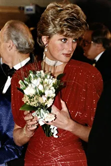 Diana, Princess of Wales holding a bouquet of flowers as she attends the premiere of Diana, Princess of Wales holding a bouquet of flowers as she attends the premiere of