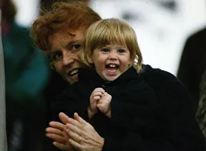 Duchess of York holds Beatrice tightly after having her pigtails pulled Duchess of York holds Beatrice tightly after having her pigtails pulled