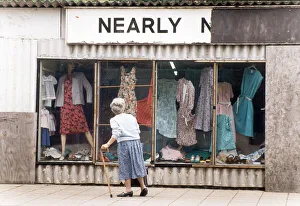 An elderly woman pauses to look at the World War Two prefab shop on the corner of An elderly woman pauses to look at the World War Two prefab shop on the corner of