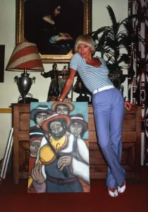 Elke Sommer, actress inside a house standing next to a painting sex Elke Sommer, actress inside a house standing next to a painting sex