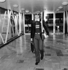 Elton John leaving Heathrow Airport for Los Angeles. November 1977 Elton John leaving Heathrow Airport for Los Angeles. November 1977