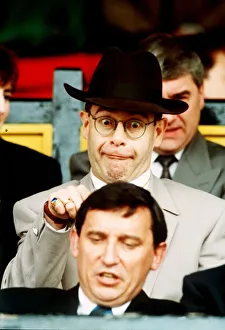 Elton John Pop Singer standing behind Graham Taylor Elton John Pop Singer standing behind Graham Taylor