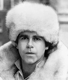 Elton John pop singer wearing a white fur hat and coat. 1978 Elton John pop singer wearing a white fur hat and coat. 1978