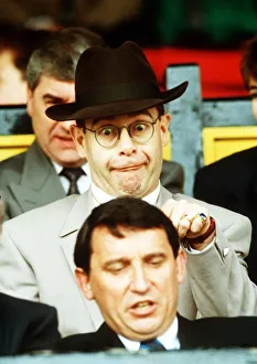 Elton John Singer & Chairman of Watford FC pulls a funny face at Manager Graham Taylor Elton John Singer & Chairman of Watford FC pulls a funny face at Manager Graham Taylor