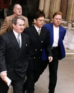 Elton John singer leaves the High Court during the libel court case against The Sunday Elton John singer leaves the High Court during the libel court case against The Sunday
