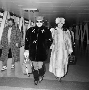 Elton John and wife Renate leaving Heathrow Airport for Washington where he is to play Elton John and wife Renate leaving Heathrow Airport for Washington where he is to play