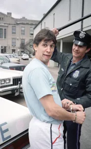 England football star Gary Lineker, is handcuffed by a police officer during a visit to a England football star Gary Lineker, is handcuffed by a police officer during a visit to a