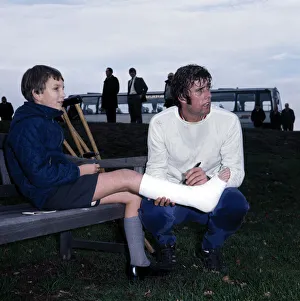 England footballer Geoff Hurst signs an autograph for a young fan in plaster caste during England footballer Geoff Hurst signs an autograph for a young fan in plaster caste during