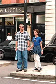 Eric Clapton musician and his daughter hold hands as they shop in the Kings Road London Eric Clapton musician and his daughter hold hands as they shop in the Kings Road London