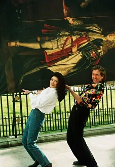 Eric Idle and Catherine Zeta Jones carrying painting 1993 Eric Idle and Catherine Zeta Jones carrying painting 1993