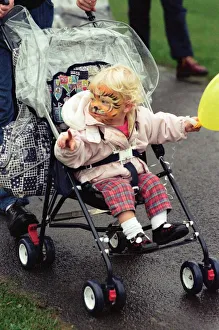 With her face painted this youngster toddled round in her pushchair during With her face painted this youngster toddled round in her pushchair during