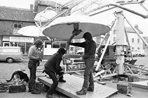 Fairground workers assembly a ride in Stokesley in preparation of the annual fair Fairground workers assembly a ride in Stokesley in preparation of the annual fair