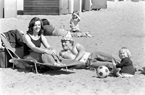 A family enjoying the hot weather at Margate Beach. April 1975 75-2073-003 A family enjoying the hot weather at Margate Beach. April 1975 75-2073-003
