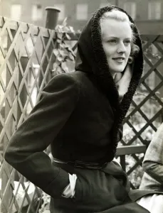 Fashion 1930s Model Waring a black wool coat with hood Fashion 1930s Model Waring a black wool coat with hood