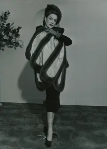 Fashion 1950s Model wearing a wild mink stole on pleated taffeta with matching gloves Fashion 1950s Model wearing a wild mink stole on pleated taffeta with matching gloves
