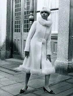 Fashion 1960s Model standing outside Carrot on Wheels boutique wearing a mid-calf Fashion 1960s Model standing outside Carrot on Wheels boutique wearing a mid-calf