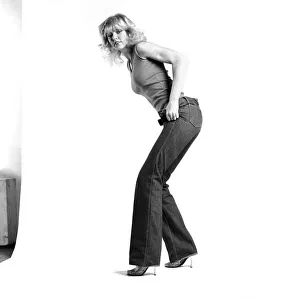Fashion: Clothing: A woman pulling up a pair of denim jeans. January 1981 81-00051-006 Fashion: Clothing: A woman pulling up a pair of denim jeans. January 1981 81-00051-006